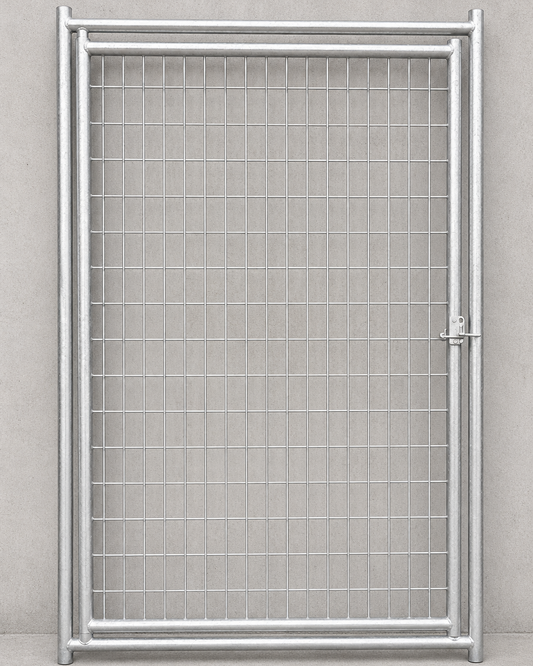 A silver metal wire mesh gate with a rectangular frame and a latch on the right side, set against a neutral gray concrete wall and floor.