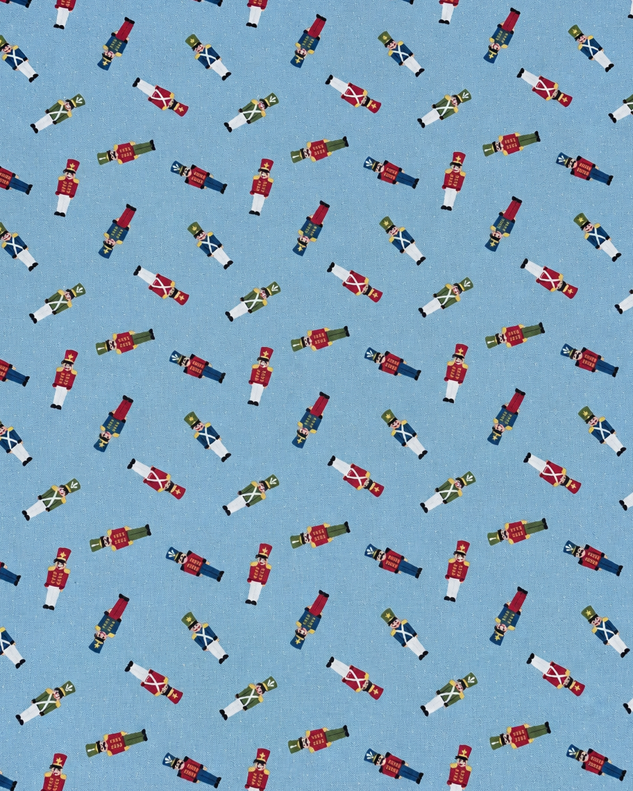 A repeating pattern of small nutcracker figures in red, white, blue, green, and gold on a light blue background.