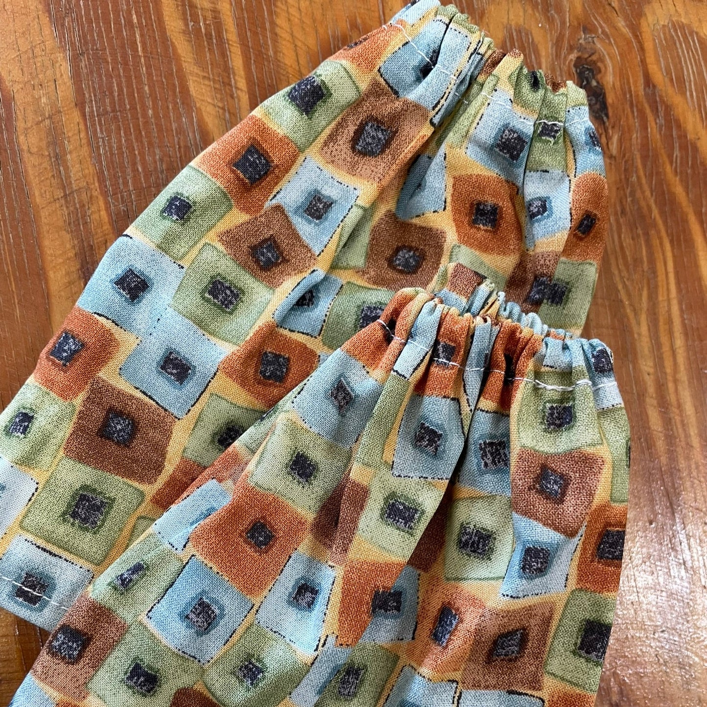 Folded sock savers on a wooden surface