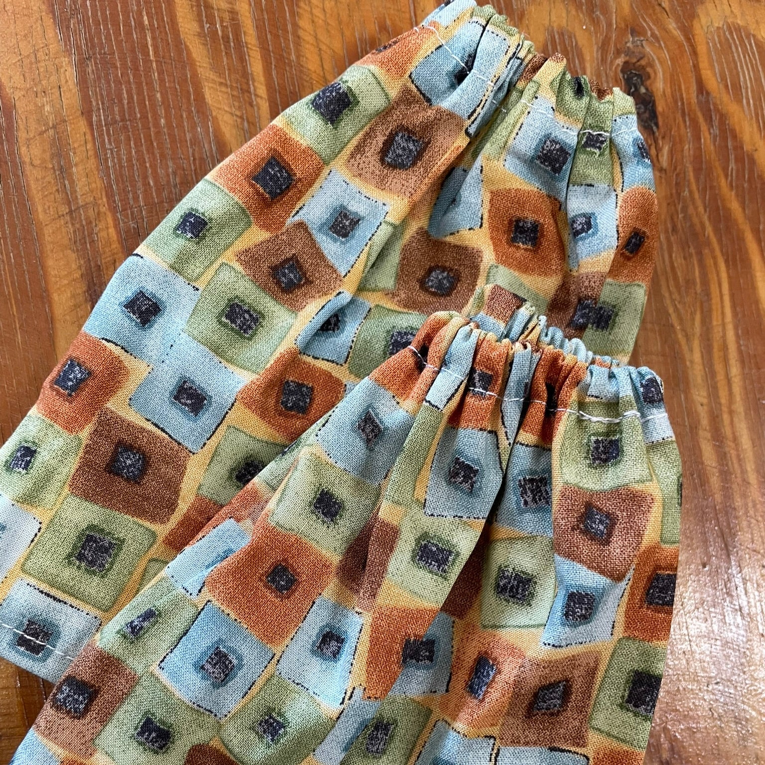 Folded sock savers on a wooden surface